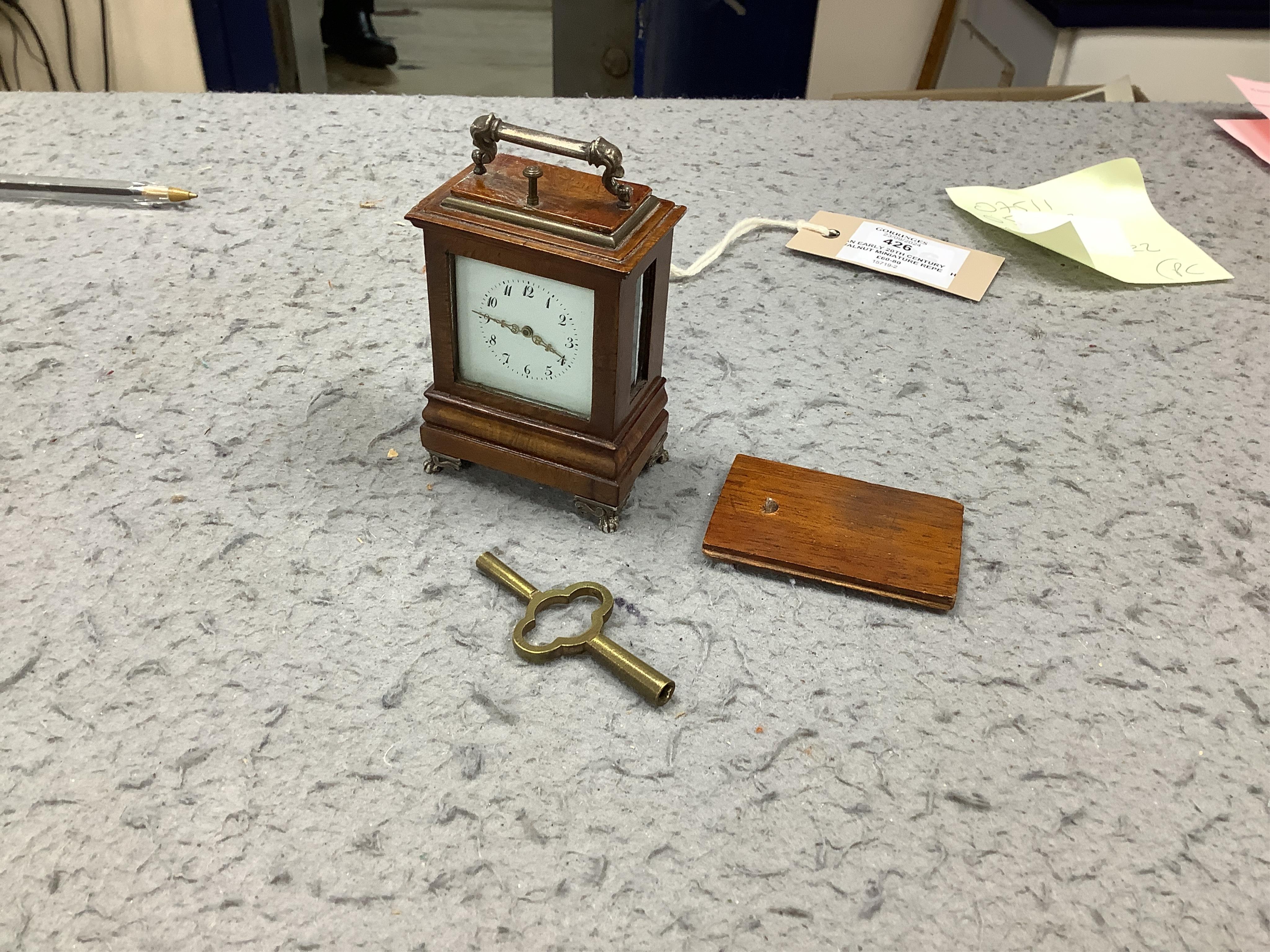 An early 20th century walnut miniature repeating carriage clock, with key, 8.5cm. Condition - fair, currently ticking